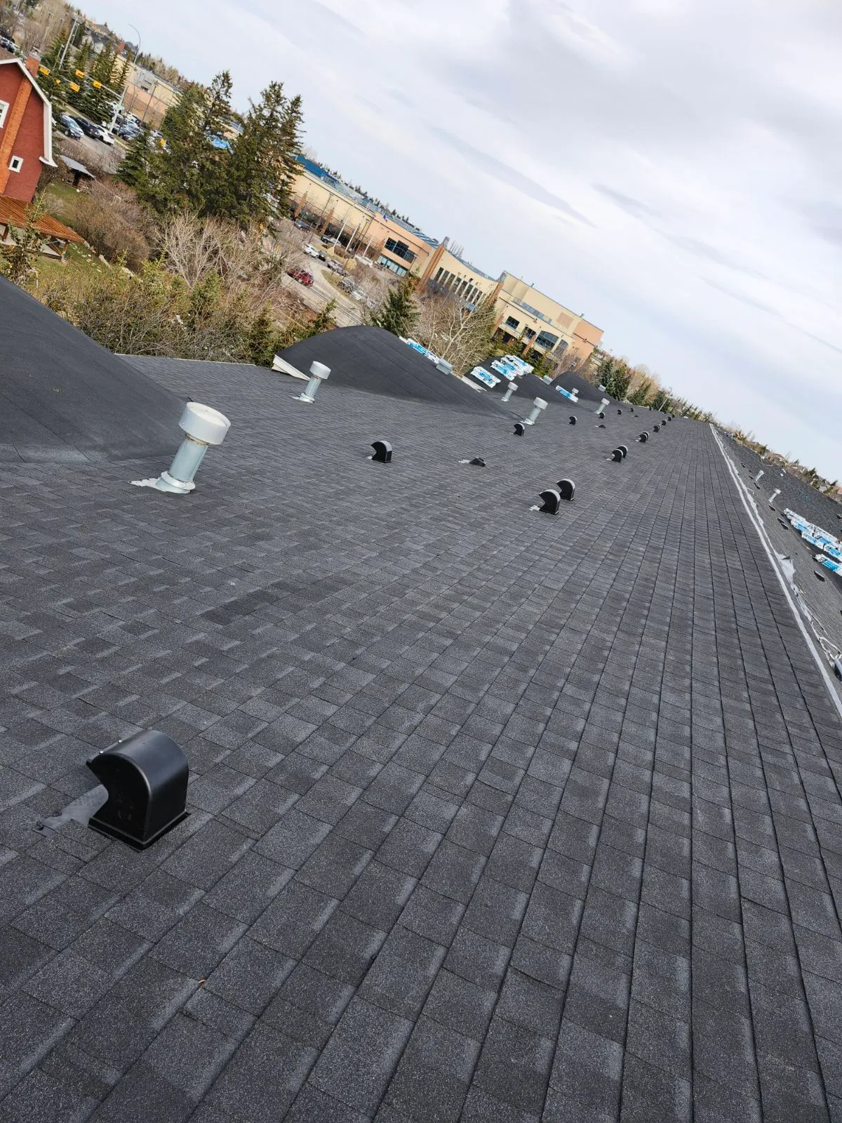 Finished charcoal Class 4 asphalt shingle roof in Calgary