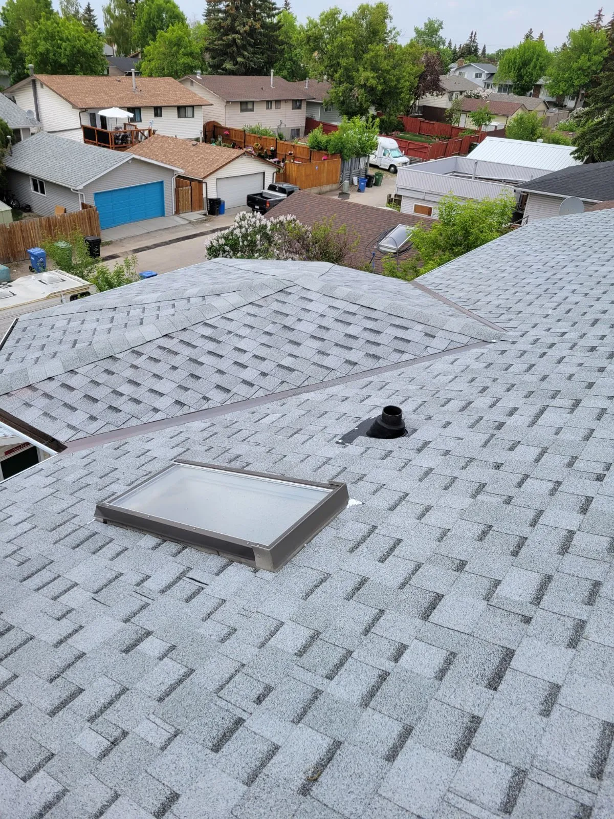 Finished Calgary roof with skylight installed by Top Star Roofing