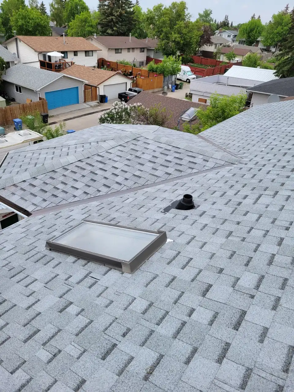 Calgary asphalt shingle roof with skylight finished by Top Star Roofing